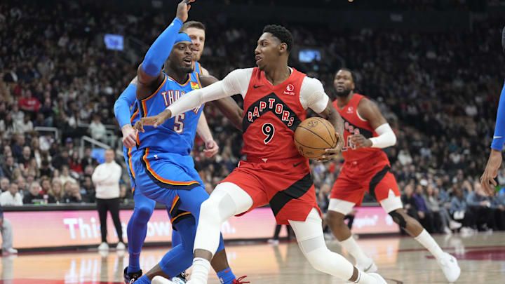 Dec 5, 2024; Toronto, Ontario, CAN;  Toronto Raptors guard RJ Barrett (9)drives to the net against Oklahoma City Thunder guard Luguentz Dort (5) during the first half at Scotiabank Arena. Mandatory Credit: John E. Sokolowski-Imagn Images