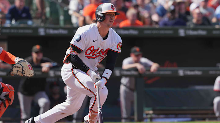 Sep 19, 2024; Baltimore, Maryland, USA; Baltimore Orioles catcher Adley Rutschman (35) drives in a run on his fourth inning double against the San Francisco Giants at Oriole Park at Camden Yards.