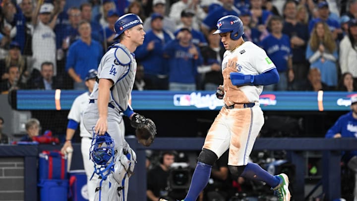 Oct 25, 2025; Toronto, Ontario, CAN; Toronto Blue Jays designated hitter George Springer (4) scores a run as Los Angeles Dodgers catcher Will Smith (16) looks on in the third inning during game two of the 2025 MLB World Series at Rogers Centre. Mandatory Credit: Dan Hamilton-Imagn Images Oct 25, 2025; Toronto, Ontario, CAN; Toronto Blue Jays designated hitter George Springer (4) scores a run as Los Angeles Dodgers catcher Will Smith (16) looks on in the third inning during game two of the 2025 MLB World Series at Rogers Centre. Mandatory Credit: Dan Hamilton-Imagn Images