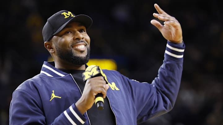 Michigan Wolverines head football coach Sherrone Moore fires up the crowd in overtime of the basketball game against the Northwestern Wildcats at Crisler Center.