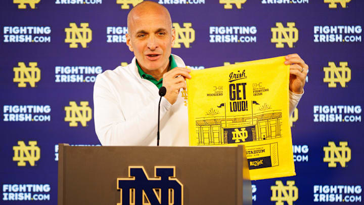During a Dec. 17 press conference, Notre Dame Athletic Director Pete Bevacqua holds up one of the towels that will be handed out during Notre Dame football's game against Indiana in the first round of the College Football Playoff at Notre Dame Stadium on Friday, Dec. 20, 2024.