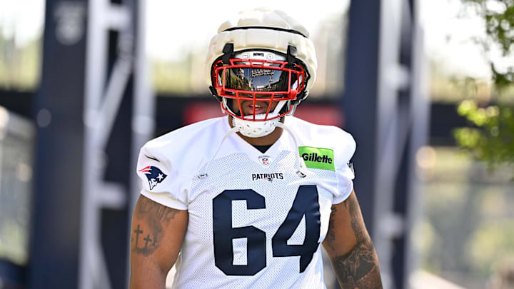 Jul 23, 2025; Foxborough, MA, USA; New England Patriots guard Layden Robinson (64) walks to the practice field for training camp at Gillette Stadium.