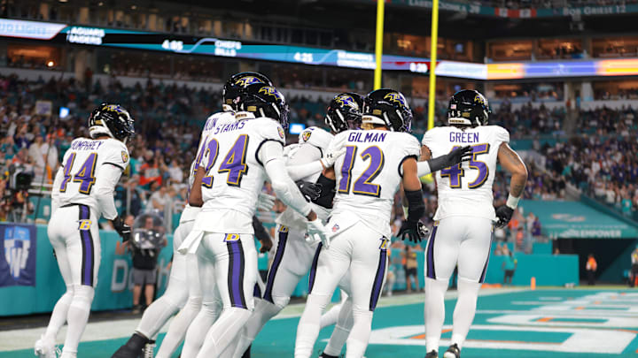 Oct 30, 2025; Miami Gardens, Florida, USA; Baltimore Ravens safety Alohi Gilman (12) celebrates a fumble recovery with teammates during the first quarter against the Miami Dolphins at Hard Rock Stadium. Mandatory Credit: Sam Navarro-Imagn Images
