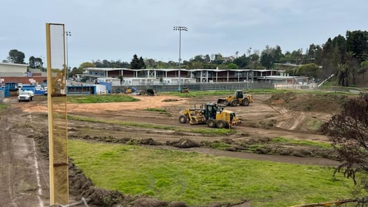 Bulldozers plow through Palisades Charter High's baseball field to create a flat surface where temporary classrooms can be placed while are rebuild of the campus takes place from the wildfires.