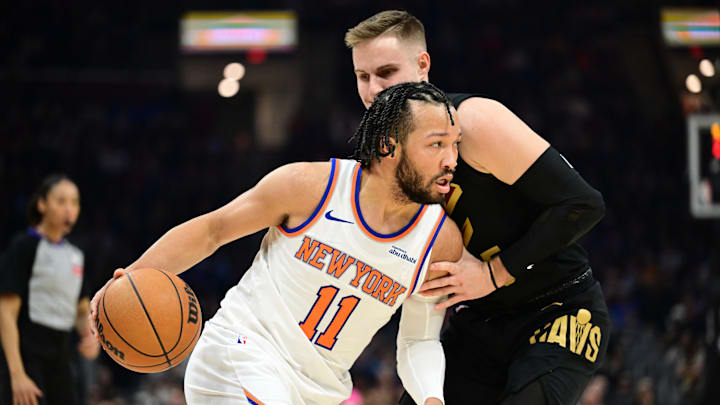 Feb 21, 2025; Cleveland, Ohio, USA;  New York Knicks guard Jalen Brunson (11) drives to the basket against Cleveland Cavaliers guard Sam Merrill (5) during the first half at Rocket Arena. Mandatory Credit: Ken Blaze-Imagn Images