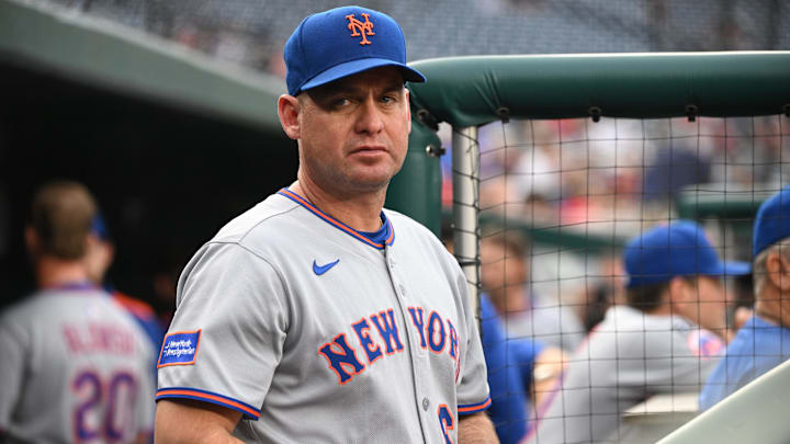 Aug 20, 2025; Washington, District of Columbia, USA;  New York Mets manager Carlos Mendoza (64) stands in the dugout before a game against the Washington Nationals at Nationals Park. Mandatory Credit: Rafael Suanes-Imagn Images