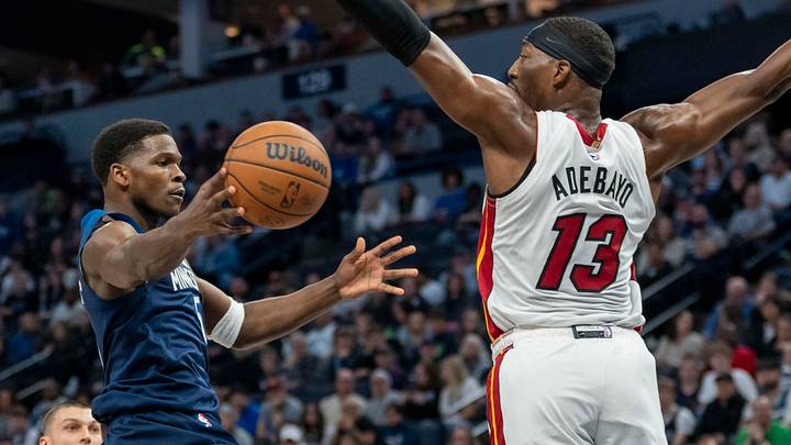 Nov 10, 2024; Minneapolis, Minnesota, USA; Minnesota Timberwolves guard Anthony Edwards (5) drives to the basket and passes the ball around Miami Heat center Bam Adebayo (13) in the first half at Target Center. Mandatory Credit: Jesse Johnson-Imagn Images