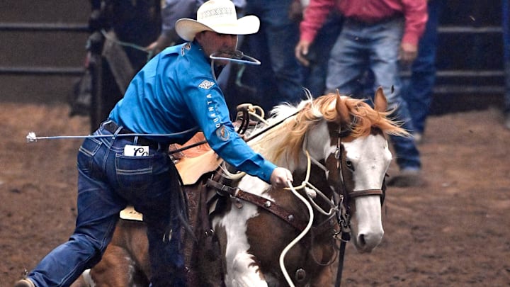 Riley Mason Webb of Denton, Texas leaps from his horse after roping a calf during Tie-Down Roping at the San Angelo Rodeo Saturday April 6, 2024. Riley Mason Webb of Denton, Texas leaps from his horse after roping a calf during Tie-Down Roping at the San Angelo Rodeo Saturday April 6, 2024.