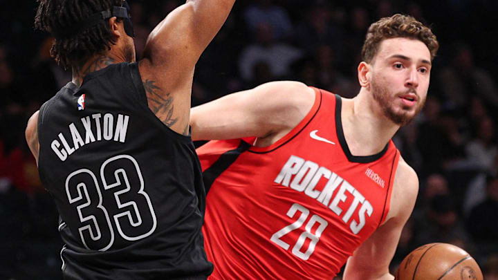Feb 4, 2025; Brooklyn, New York, USA; Houston Rockets center Alperen Sengun (28) looks to pass as Brooklyn Nets center Nic Claxton (33) defends during the first quarter at Barclays Center. Mandatory Credit: Vincent Carchietta-Imagn Images