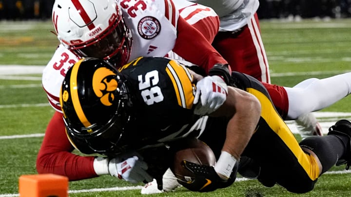 Iowa  tight end Luke Lachey is tackled by Nebraska linebacker Javin Wright short of the goal line.
