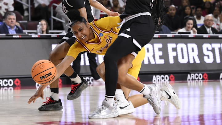 Mar 24, 2025; Los Angeles, California, USA; USC Trojans guard JuJu Watkins (12) injures her knee in the first quarter of an NCAA Tournament second round game against the Mississippi State Bulldogs at Galen Center. Mandatory Credit: Robert Hanashiro-Imagn Images