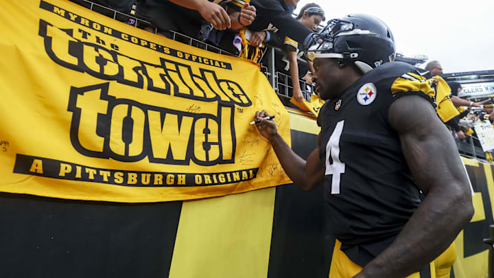 Oct 12, 2025; Pittsburgh, Pennsylvania, USA; Pittsburgh Steelers wide receiver DK Metcalf (4) signs a fan’s terrible towel after the game at Acrisure Stadium. 