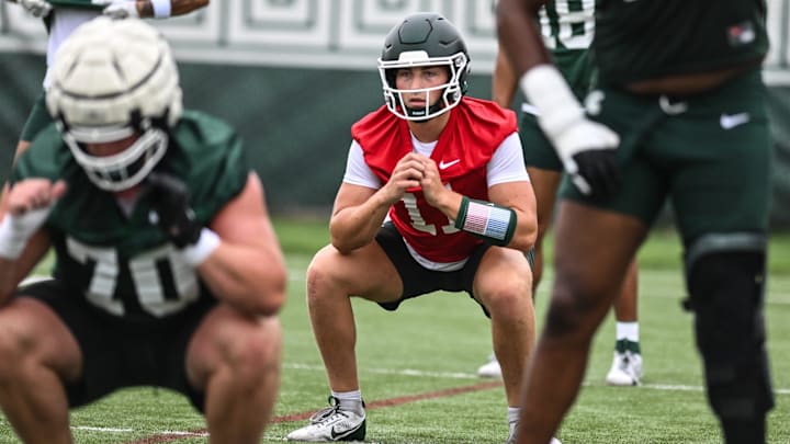 MSU QB Alessio Milivojevic and teammates warm up, Tuesday, July 29, 2025, during the first day of football practice at the Skandalaris Football Center.