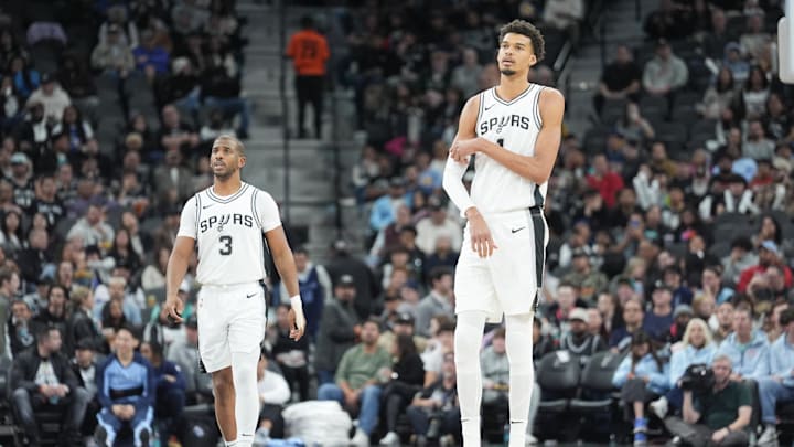 Jan 17, 2025; San Antonio, Texas, USA; San Antonio Spurs guard Chris Paul (3) and center Victor Wembanyama (1) look on in the second half against the Memphis Grizzlies at Frost Bank Center. Mandatory Credit: Daniel Dunn-Imagn Images