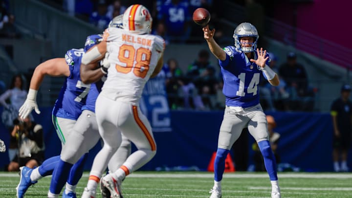 Oct 5, 2025; Seattle, Washington, USA; Seattle Seahawks quarterback Sam Darnold (14) throws downfield against the Tampa Bay Buccaneers during the first half at Lumen Field. 