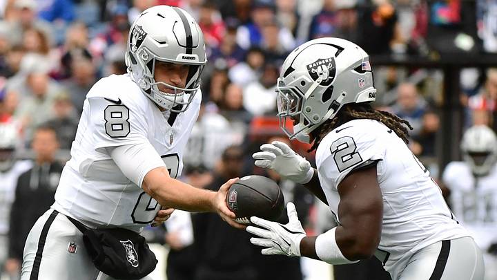 Oct 11, 2026; Foxborough, Massachusetts, USA;  Las Vegas Raiders quarterback Kirk Cousins (8) hands the ball to running back Ashton Jeanty (2) against the New England Patriots during the first quarter at Gillette Stadium.  Mandatory Credit: Bob DeChiara-Imagn Images