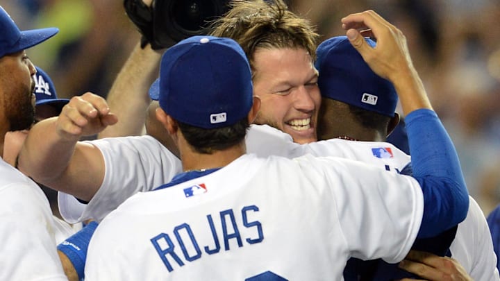 Jun 18, 2014; Los Angeles, CA, USA;    Los Angeles Dodgers starting pitcher Clayton Kershaw (22) celebrates with shortstop Miguel Rojas (72) and outfielder Yasiel Puig (66) after the final out of his no-hitter against the Colorado Rockies at Dodger Stadium. Dodgers won 8-0.Mandatory Credit: Jayne Kamin-Oncea-Imagn Images