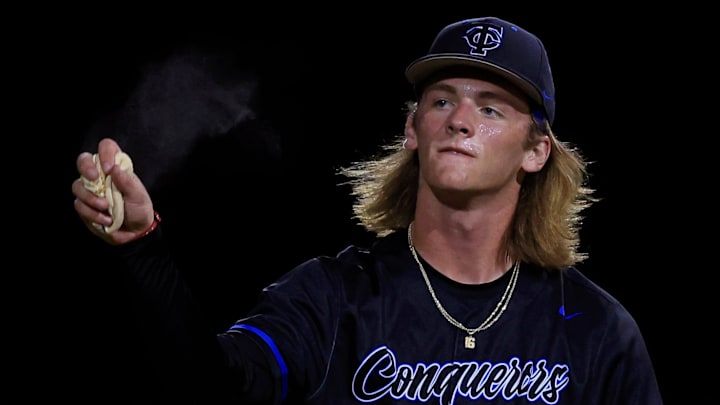 Trinity Christian's Ethan Wheeler (16) tosses a bag of rosin on the mound while pitching during the fourth and final inning of a FHSAA District 2-3A high school baseball tournament final Thursday, May 2, 2024 at Trinity Christian Academy in Jacksonville, Fla. The Trinity Christian Conquerors blanked the Bishop Snyder Cardinals 14-0.