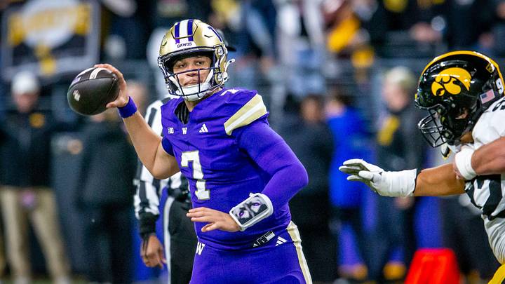 Husky quarterback Elijah Brown throws the ball under Iowa pressure. 