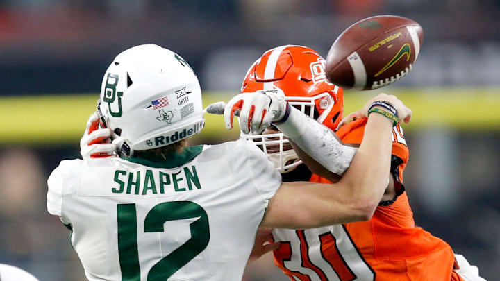 OSU's Collin Oliver (30) sacks Baylor's Blake Shapen (12) and forces him to fumble out of bounds in the Big 12 title game.