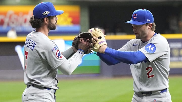 Oct 11, 2025; Milwaukee, Wisconsin, USA; Chicago Cubs shortstop Dansby Swanson (7) and second baseman Nico Hoerner (2) high five before game five against the Milwaukee Brewers in the NLDS round for the 2025 MLB playoffs at American Family Field. Mandatory Credit: Michael McLoone-Imagn Images