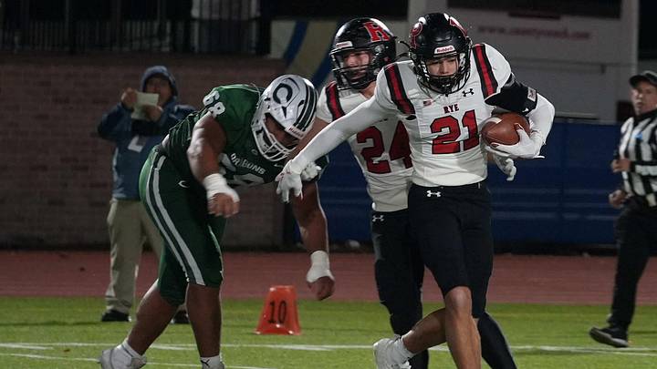 Luke Denvir (21) competes for the Rye football team in the New York State Class A semifinals against Cornwall Central last season. The Garnets won, 35-7.