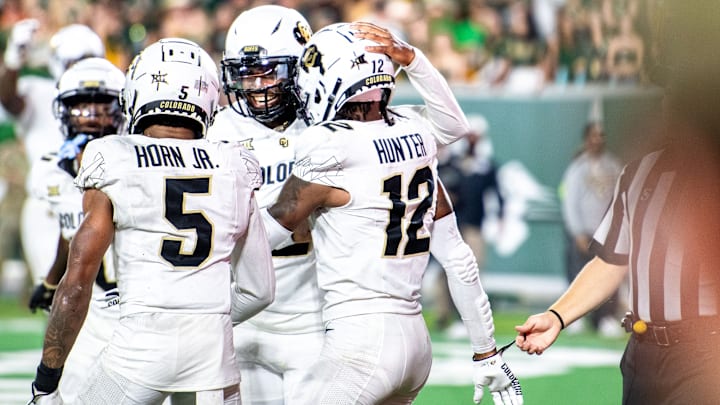 CU football athlete Travis Hunter (12), quarterback Shadeur Sanders (middle) and wide receiver Jimmy Horn Jr. celebrate Hunter's touchdown reception against CSU in the Rocky Mountain Showdown at Canvas Stadium on Saturday, Sept. 14, 2024, in Fort Collins, Colo.