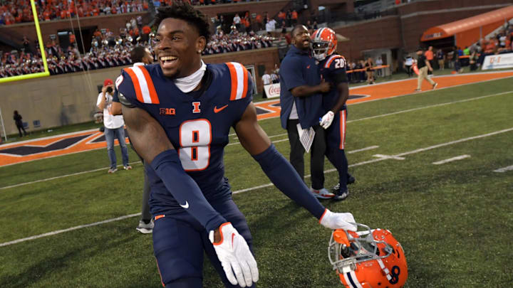 Oct 12, 2024; Champaign, Illinois, USA;  Illinois Fighting Illini defensive back Terrance Brooks (8) celebrates his team’s 50-49 overtime win over the Purdue Boilermakers at Memorial Stadium. Mandatory Credit: Ron Johnson-Imagn Images