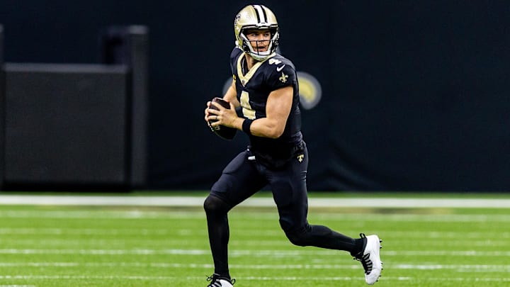 Nov 17, 2024; New Orleans, Louisiana, USA;  New Orleans Saints quarterback Derek Carr (4) rolls out the pocket against the Cleveland Browns during the first half at Caesars Superdome. Mandatory Credit: Stephen Lew-Imagn Images