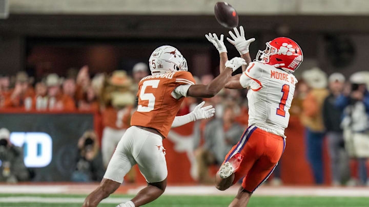 Dec 21, 2024; Austin, Texas, USA; Clemson Tigers wide receiver T.J. Moore (1) catches the ball for a first down against Texas Longhorns defensive back Malik Muhammad (5) in the second half at Darrell K Royal Texas Memorial Stadium.  Mandatory Credit: Ricardo B. Brazziell/USA Today Network via Imagn Images