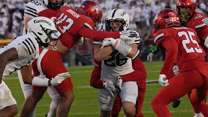 Iowa State Cyclones' running back Carson Hansen (26) breaks tackle from Arizona Wildcats defensive back Dalton Johnson (43) and runs for a first down during the first quarter in the Big-12 conference showdown on Sept. 27, 2025, at Jack Trice Stadium in Ames, Iowa.