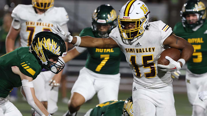 Simi Valley High's Brice Hawkins stiff-arms Royal's Tevin Ware during the third quarter of their rivalry game at Royal High on Friday, Sept. 6, 2024. The Pioneers won 62-10 to reach 3-0 on the season.