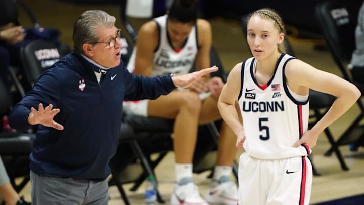 Mar 1, 2021; Storrs, Connecticut, USA; UConn Huskies head coach Geno Auriemma talks with guard Paige Bueckers (5) during a break in the first quarter against the Marquette Golden Eagles at Harry A. Gampel Pavilion. Mandatory Credit: David Butler II-Imagn Images Mar 1, 2021; Storrs, Connecticut, USA; UConn Huskies head coach Geno Auriemma talks with guard Paige Bueckers (5) during a break in the first quarter against the Marquette Golden Eagles at Harry A. Gampel Pavilion. Mandatory Credit: David Butler II-Imagn Images