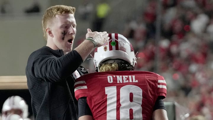 Injured Wisconsin quarterback Billy Edwards Jr. congratulates quarterback Danny O'Neil after a touchdown pass during the fourth quarter of their game Thursday, August 28, 2025 at Camp Randall Stadium in Madison, Wisconsin. Wisconsin beat Miami (Ohio) 17-0.