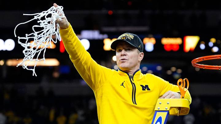 Michigan head coach Dusty May swings the net after winning the NCAA national championship against Connecticut at Lucas Oil Stadium in Indianapolis on Monday, April 6, 2026. Michigan head coach Dusty May swings the net after winning the NCAA national championship against Connecticut at Lucas Oil Stadium in Indianapolis on Monday, April 6, 2026.