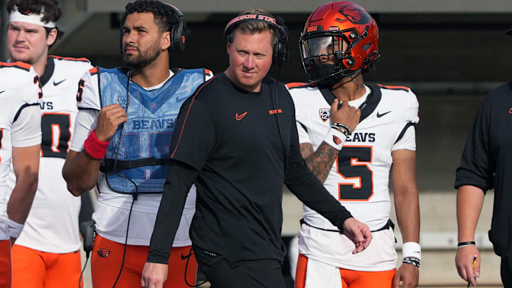 Oct 26, 2024; Berkeley, California, USA; Oregon State Beavers head coach Trent Bray (center) walks on the sideline in front of quarterbacks Dom Montiel (center left) and Gabarri Johnson (5) during the fourth quarter against the California Golden Bears at California Memorial Stadium. Mandatory Credit: Darren Yamashita-Imagn Images