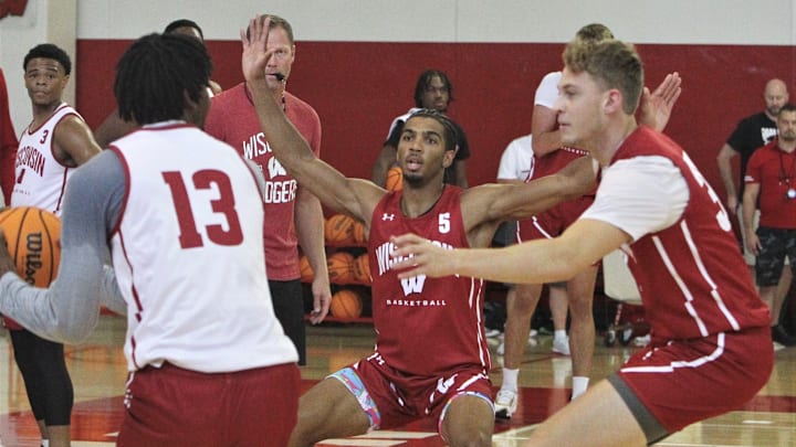Wisconsin men's basketball player Daniel Freitag (5) and Marcus Ilver defend Xavier Amos (13) during practice at Nicholas Johnson Pavillion in Madison, Wisconsin on Thursday Sept. 26, 2024 Wisconsin men's basketball player Daniel Freitag (5) and Marcus Ilver defend Xavier Amos (13) during practice at Nicholas Johnson Pavillion in Madison, Wisconsin on Thursday Sept. 26, 2024