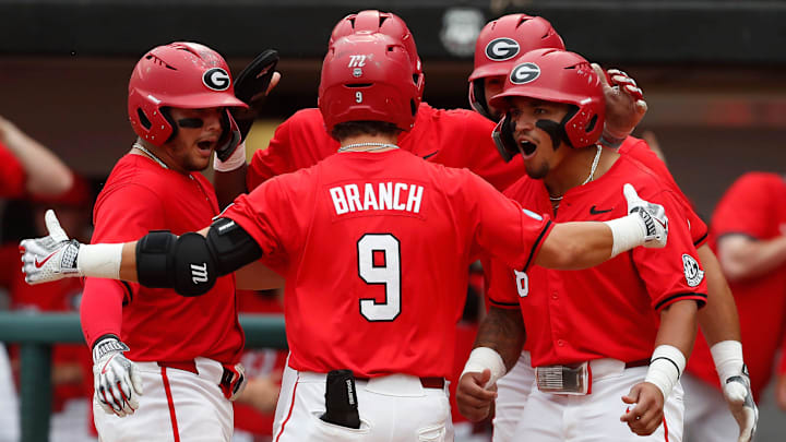 Georgia's Kolby Branch (9) celebrates with his teammates after hitting a grand slam during a NCAA Athens Regional baseball game against UNCW in Athens, Ga., on Saturday, June 1, 2024.