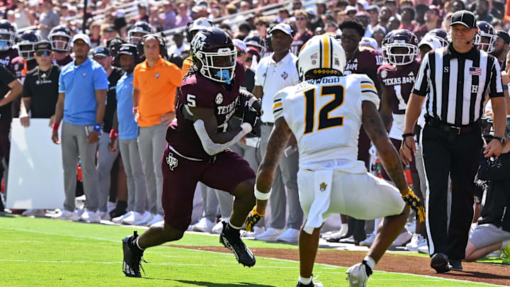 Oct 5, 2024; College Station, Texas, USA;  Texas A&M Aggies running back Amari Daniels (5) runs the ball for a touchdown in the first quarter against the Missouri Tigers at Kyle Field. Mandatory Credit: Maria Lysaker-Imagn Images. 