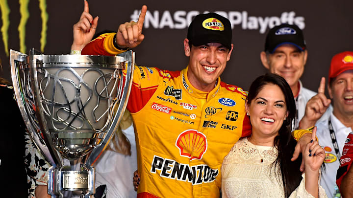 NASCAR Cup Series driver Joey Logano (22) celebrates winning the Ford EcoBoost 400 and the NASCAR Cup Series Championship with his wife Brittany at Homestead-Miami Speedway. 