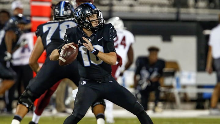 Nov 1, 2018; Orlando, FL, USA; UCF Knights quarterback McKenzie Milton (10) throws a touchdown pass during the first quarter against the Temple Owls at Spectrum Stadium. Mandatory Credit: Reinhold Matay-USA TODAY Sports
