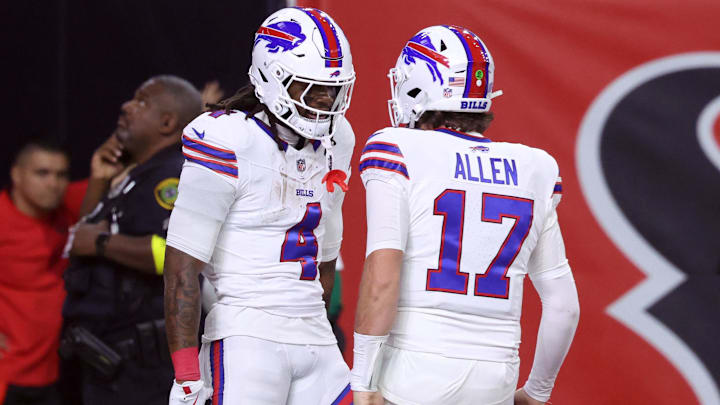 Buffalo Bills RB James Cook III celebrates with QB Josh Allen after scoring a touchdown against the Houston Texans.