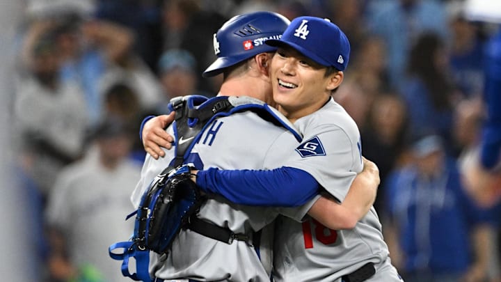 Oct 25, 2025; Toronto, Ontario, CAN; Los Angeles Dodgers pitcher Yoshinobu Yamamoto (18) and catcher Will Smith (16) celebrate after defeating the Toronto Blue Jays in game two of the 2025 MLB World Series Oct 25, 2025; Toronto, Ontario, CAN; Los Angeles Dodgers pitcher Yoshinobu Yamamoto (18) and catcher Will Smith (16) celebrate after defeating the Toronto Blue Jays in game two of the 2025 MLB World Series