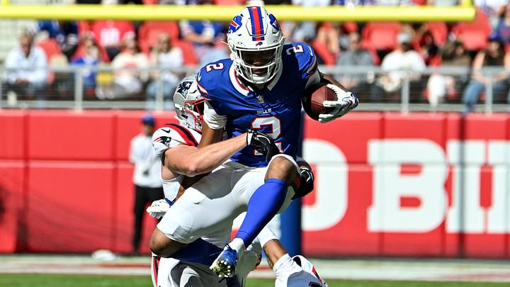 Oct 4, 2026; Orchard Park, New York, USA; Buffalo Bills wide receiver DJ Moore #2 jumps over New England Patriots cornerback Charles Woods #22 during the first quarter at New Highmark Stadium. Mandatory Credit: Mark Konezny-Imagn Images Oct 4, 2026; Orchard Park, New York, USA; Buffalo Bills wide receiver DJ Moore #2 jumps over New England Patriots cornerback Charles Woods #22 during the first quarter at New Highmark Stadium. Mandatory Credit: Mark Konezny-Imagn Images
