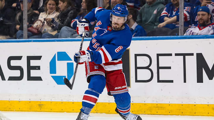 Mar 22, 2025; New York, New York, USA; New York Rangers center J.T. Miller (8) clears the puck against the Vancouver Canucks during the second period at Madison Square Garden. Mandatory Credit: Danny Wild-Imagn Images
