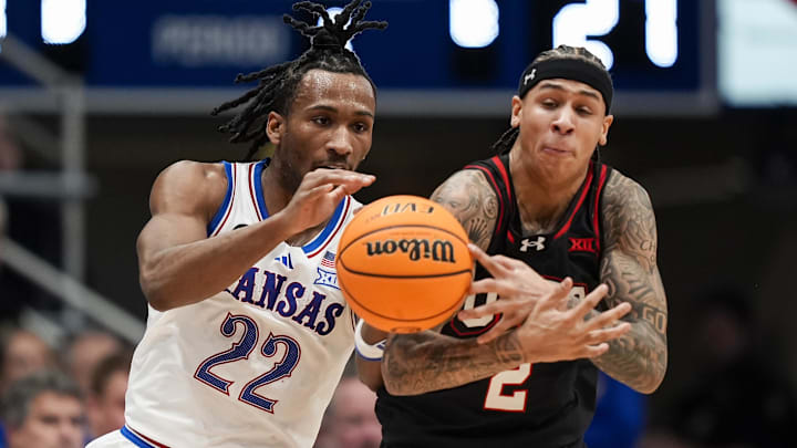 Feb 7, 2026; Lawrence, Kansas, USA; Utah Utes guard Terrence Brown (2) steals the ball from Kansas Jayhawks guard Darryn Peterson (22) during the first half at Allen Fieldhouse. Mandatory Credit: Jay Biggerstaff-Imagn Images