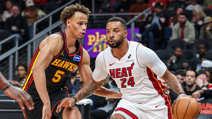 Dec 26, 2025; Atlanta, Georgia, USA; Miami Heat guard Norman Powell (24) dribbles the ball towards the goal against Atlanta Hawks guard Dyson Daniels (5) during the first quarter at State Farm Arena. Mandatory Credit: Jordan Godfree-Imagn Images