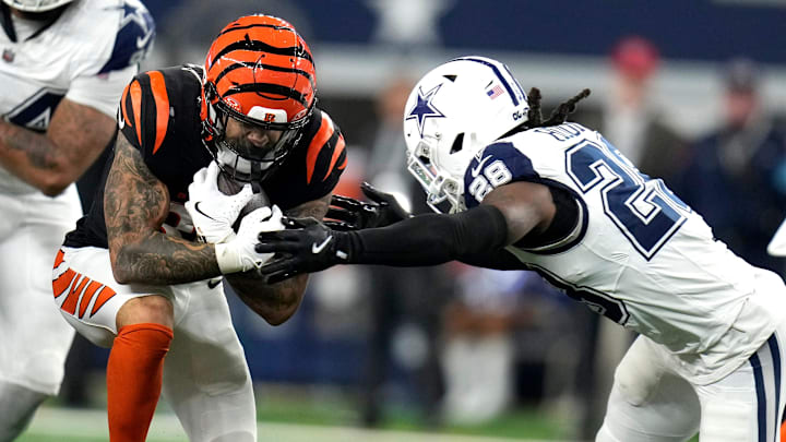 Cincinnati Bengals running back Chase Brown (30) tries to breakthrough the defense of Dallas Cowboys safety Malik Hooker (28) in the 2nd half of Monday Night Football at AT&T Stadium in Arlington,Texas on Monday, December 9, 2024. Cincinnati Bengals running back Chase Brown (30) tries to breakthrough the defense of Dallas Cowboys safety Malik Hooker (28) in the 2nd half of Monday Night Football at AT&T Stadium in Arlington,Texas on Monday, December 9, 2024.