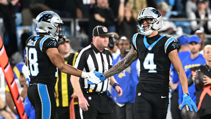 Jan 10, 2026; Charlotte, NC, USA; Carolina Panthers wide receiver Tetairoa McMillan (4) reacts with wide receiver Jalen Coker (18) in the second half during the NFC Wild Card Round game at Bank of America Stadium. Mandatory Credit: Bob Donnan-Imagn Images