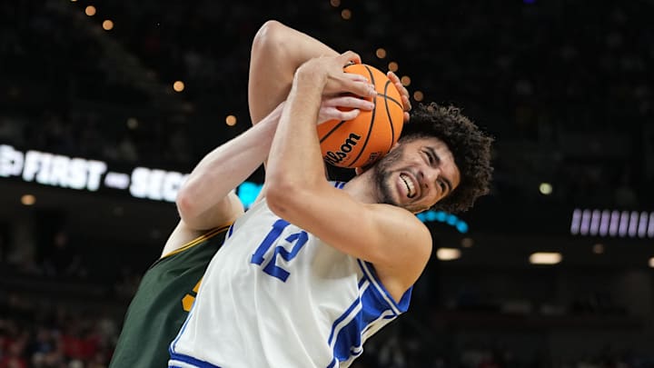 Duke Blue Devils forward Cameron Boozer reacts while getting a rebound against Siena Saints center Riley Mulvey.